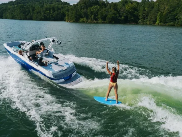 Wake/surf boat underway on lake